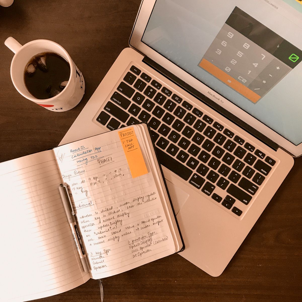 Notebook and pen beside a laptop showing a planned break schedule
